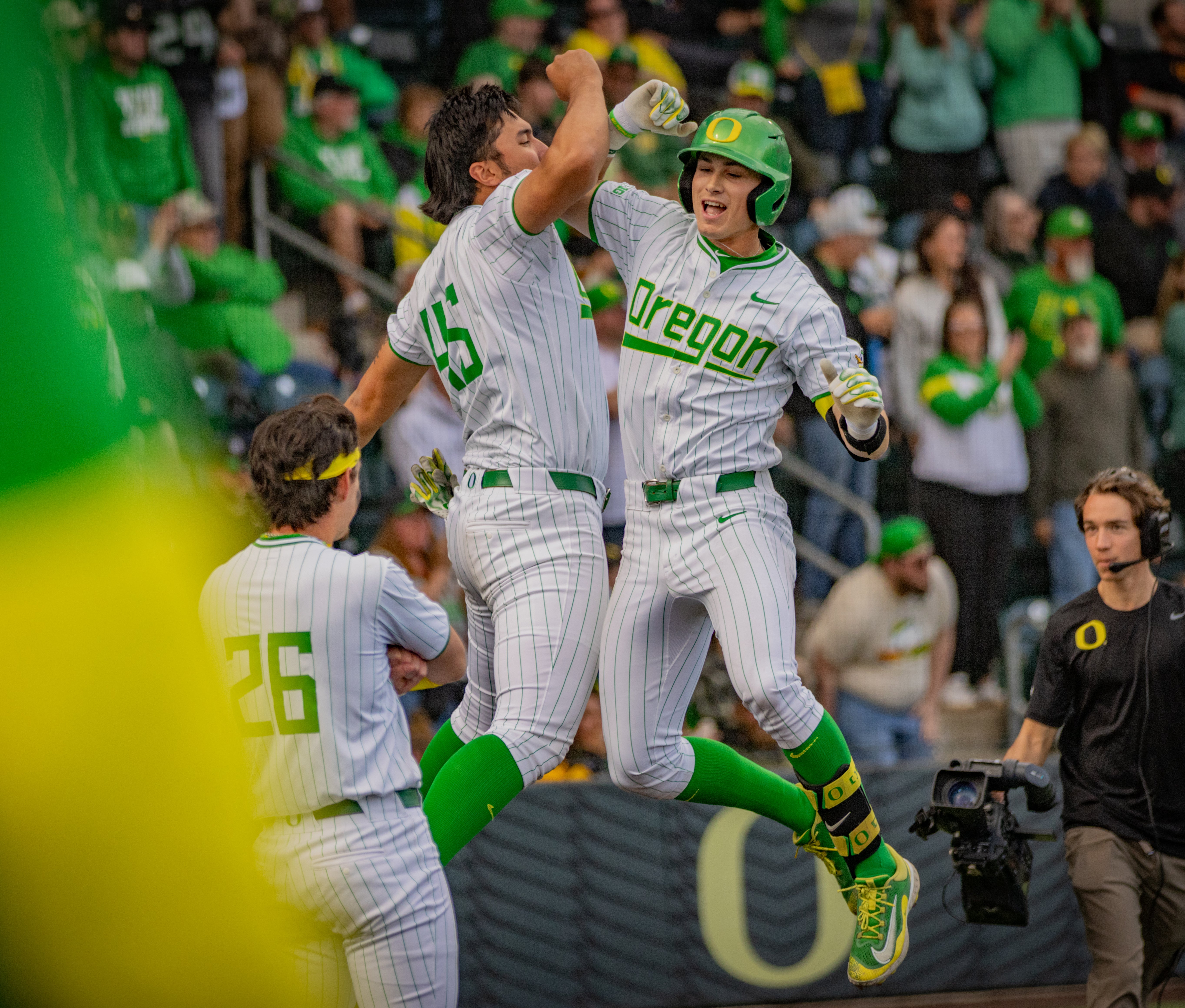 Members of the Oregon baseball team jump in celebration during their victory over Oregon State on April 26, 2025.