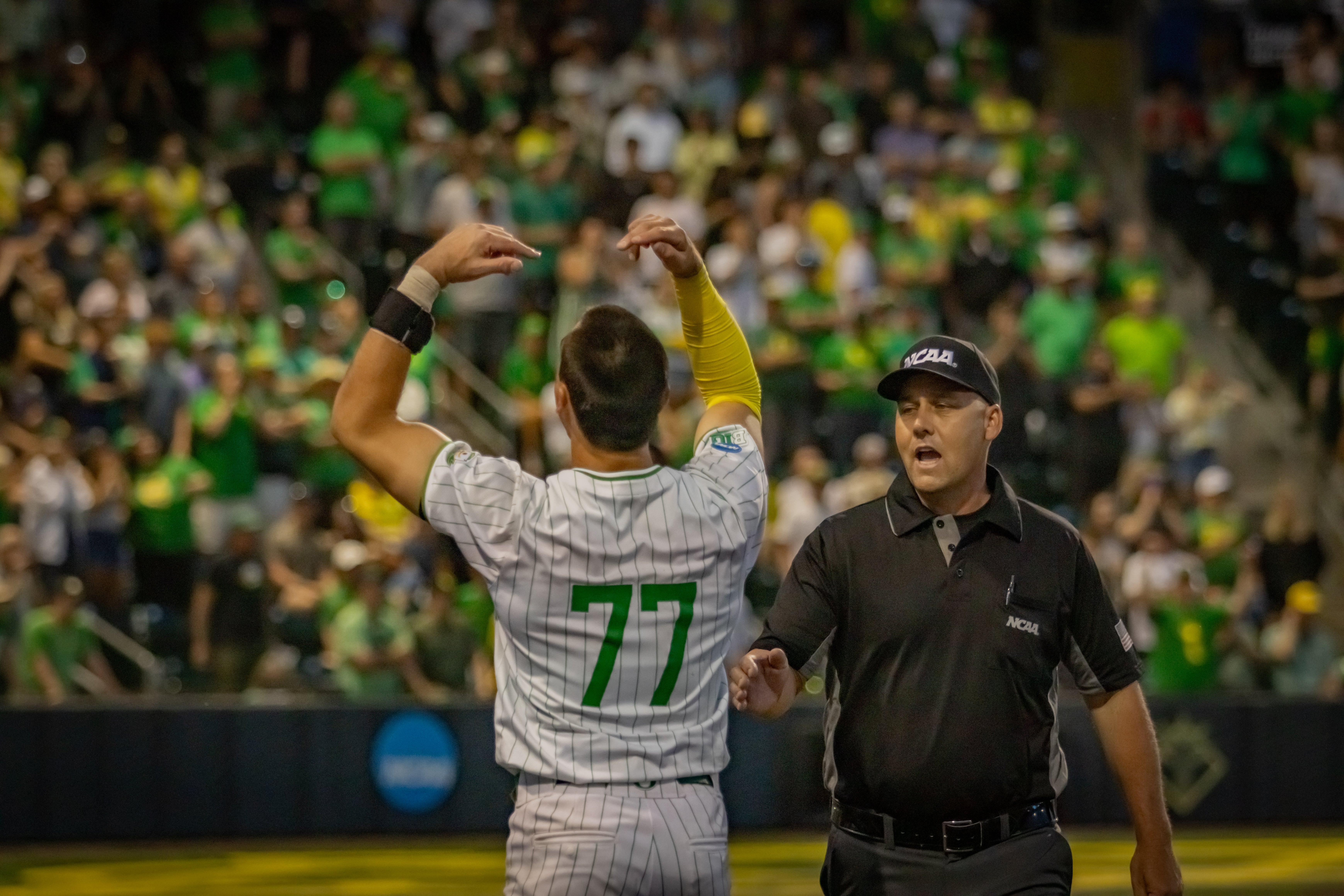 Oregon baseball's Anson Aroz and the umpire during the Ducks' controversal Eugene Regional opener.