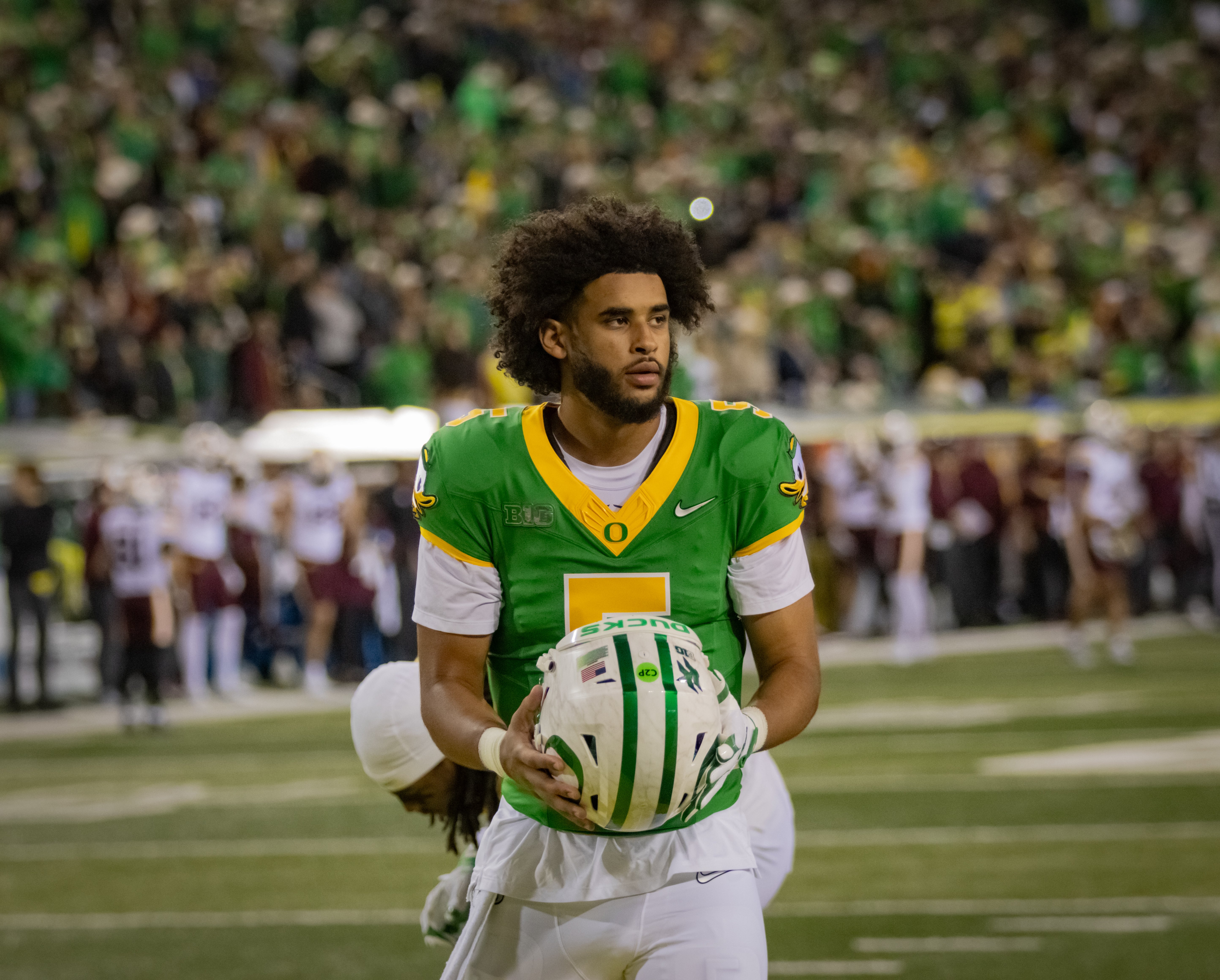Quarterback Dante Moore takes off his helmet during Oregon Football's game against the Minnesota Golden Gophers