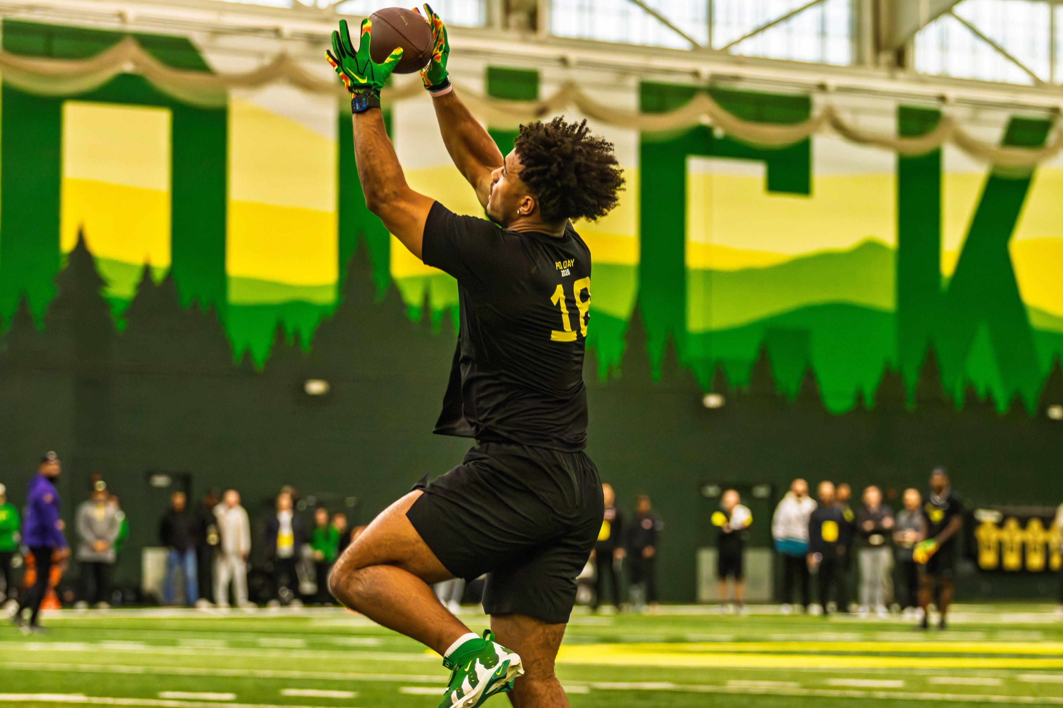 Oregon tight end Kenyon Sadiq leaps to catch a pass during the Ducks' Pro Day