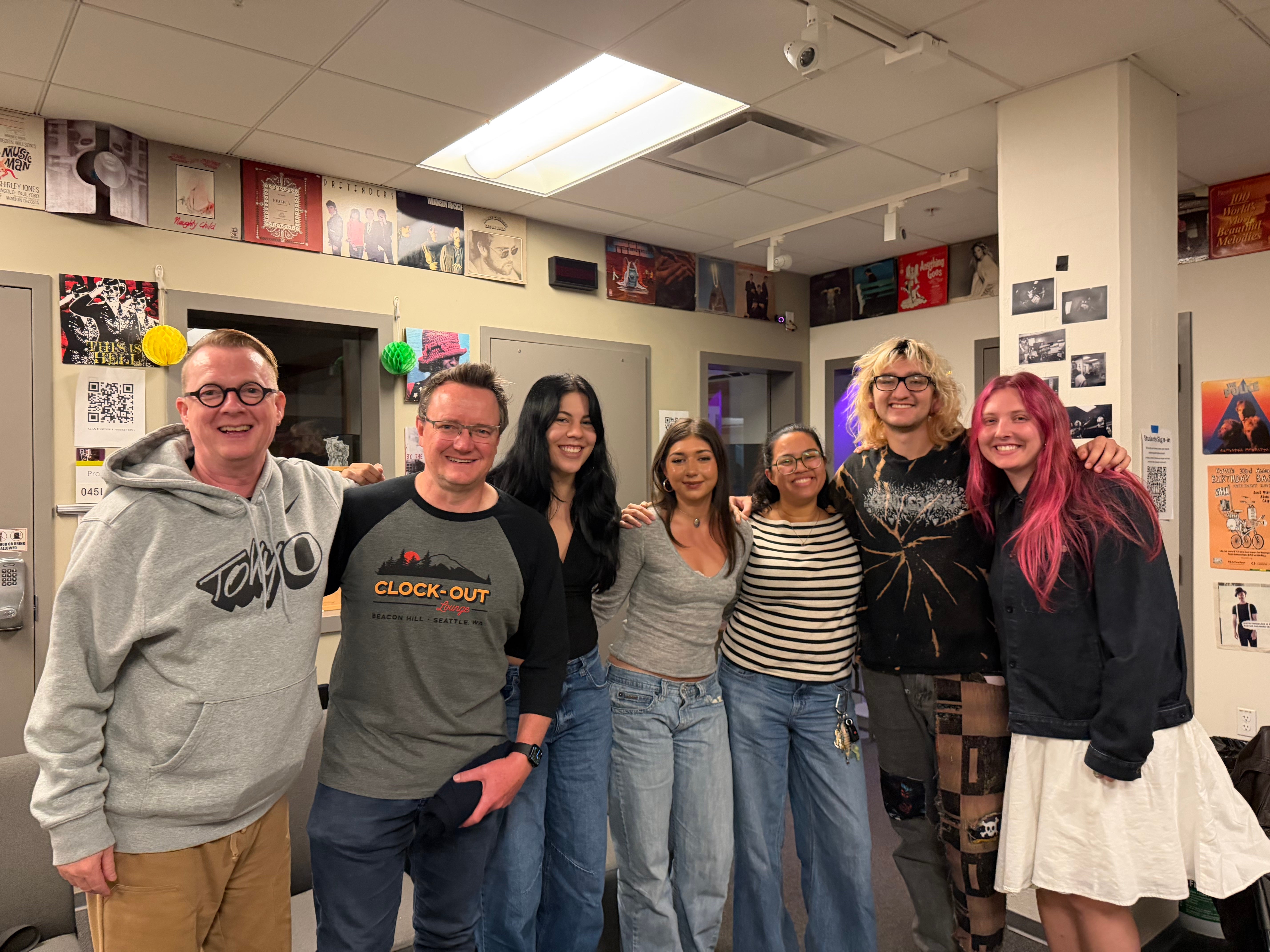 Photo: KWVA alumni and current student staff during their October 2026 visit. From left: John Thomas, Bill Trinen, Sam Polis (Music Director), Chloe Baldwin (Office Assistant), Carole Ann Balkcom (Assistant Music/Blog Director), Niko Paroissien-Arce (Production Coordinator), and Hannah Bard (News Director).Photo by Charlotte Nisser Allen / KWVA.